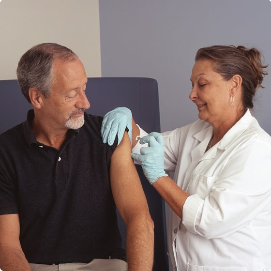 Nurse giving shot to patient