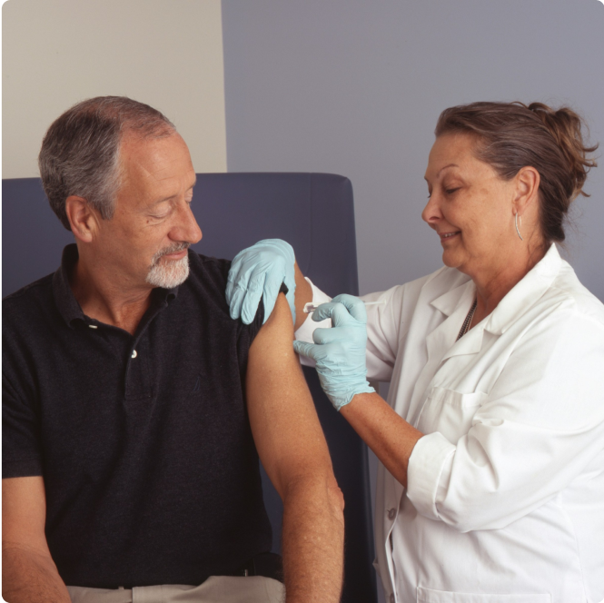 Nurse giving shot to patient